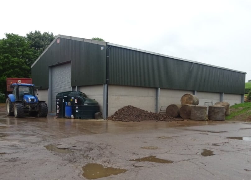 Farm building in Hamstall Ridware with tractor and hay bales in front