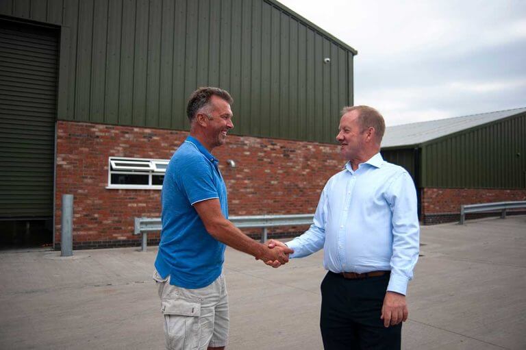 Chris Timothy shaking hands with Ian Hidderley at Elford Lowe Farm